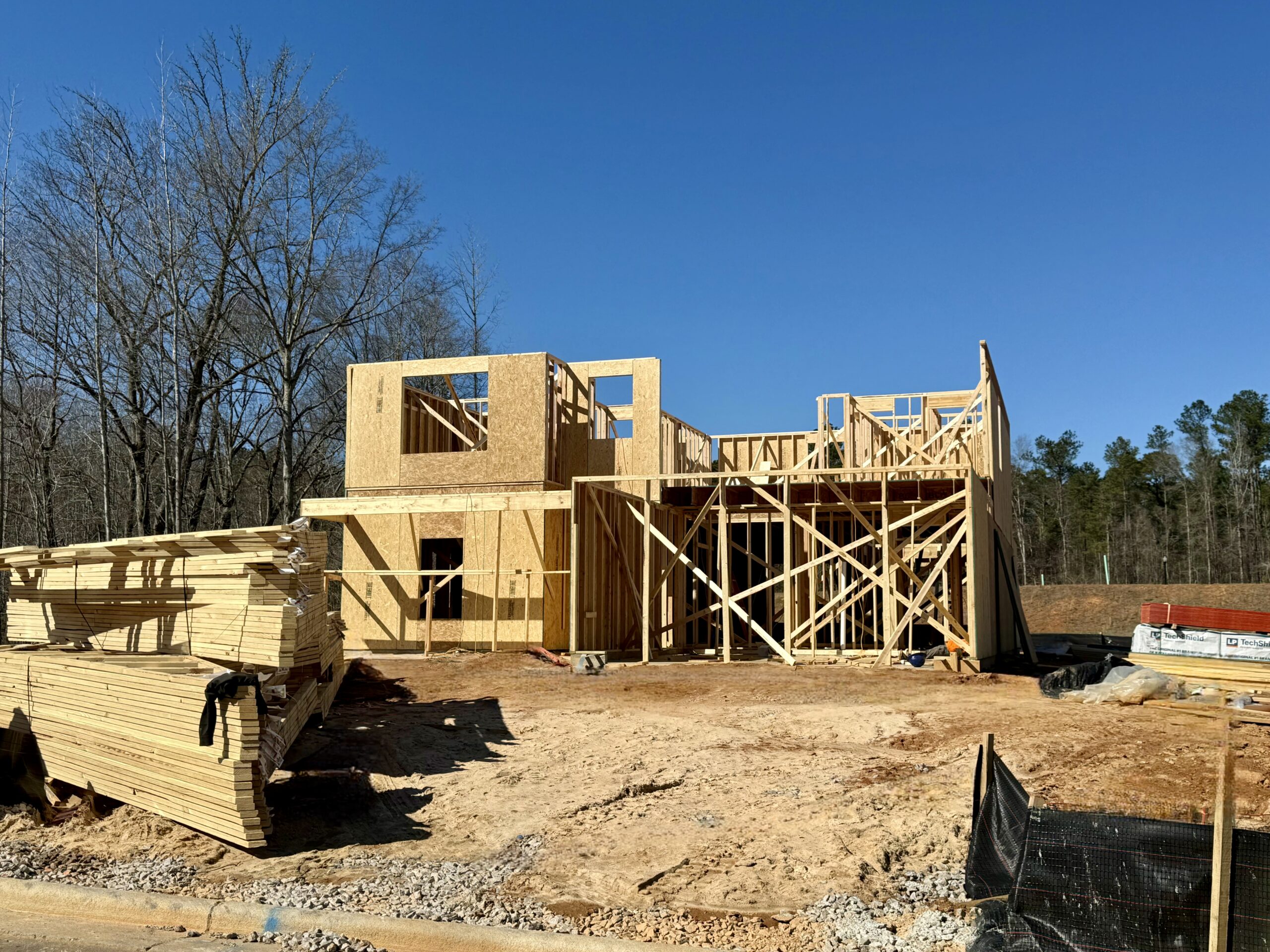 In-progress quick move-in home under construction with framing visible